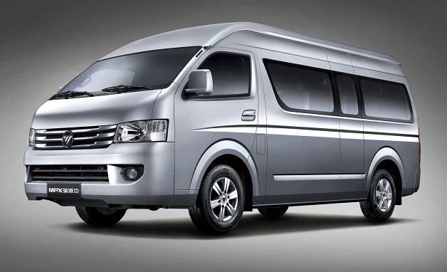 the silver van is parked in front of a gray background