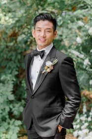 Groom in Classic Black Tuxedo with White Ranunculus Boutonniere