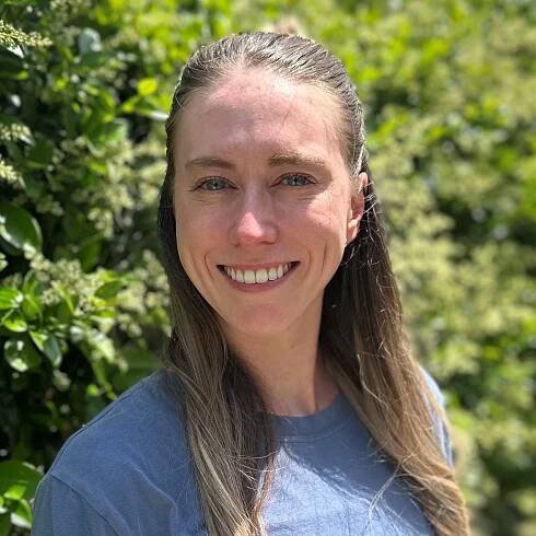 Kinley McCoury, PT, DPT, smiling in front of greenery, representing the dedicated physical therapy team at Advance in Motion Physical Therapy in Wilmington.