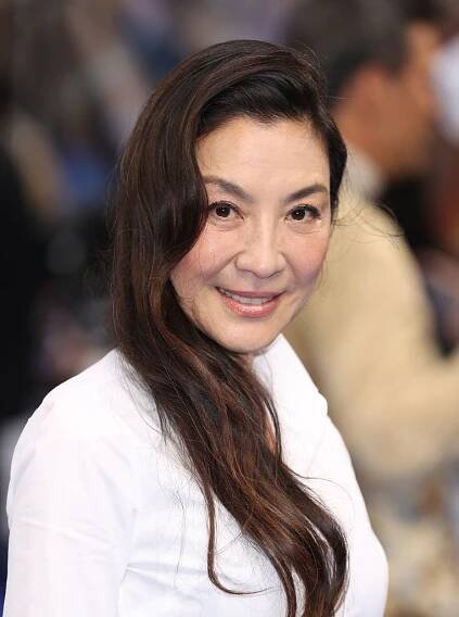 Michelle Yeoh long, side-swept wavy hair 
