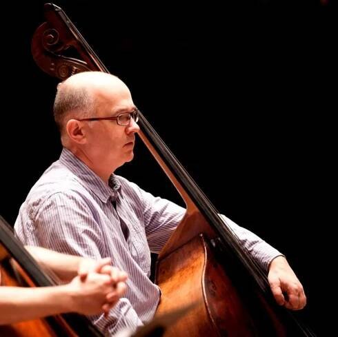 A man playing the double bass