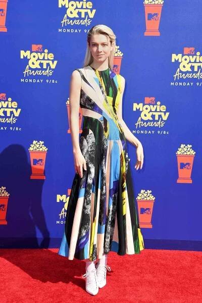 Hunter Schafer wearing a multi-colored dress on the red carpet