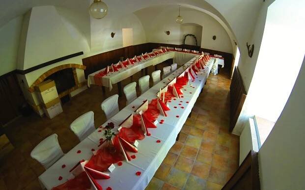 a group of tables in a church with red seats at Penzion Zámek Rozsochatec in Rozsochatec