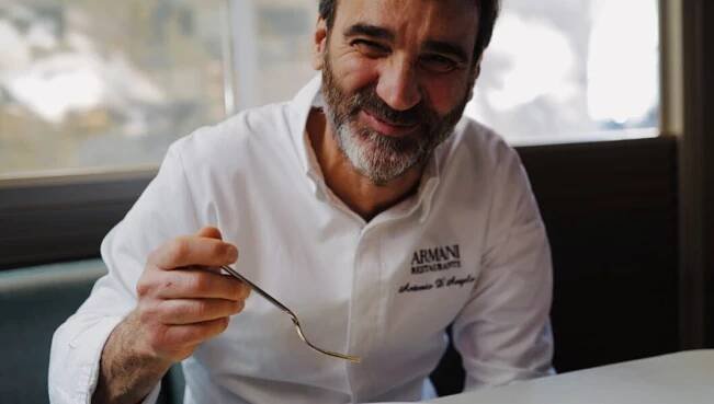 Executive Chef Antonio D’Angelo digging into saffron risotto