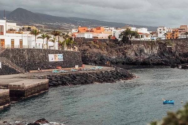 Fishing wharf area lined with sun loungers in Alcala town