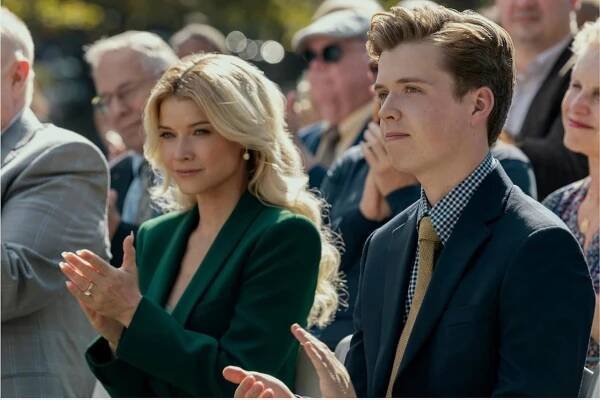 Sarah Jones as Serena Croker and Evan Roe as Wally Croker applaud at an event in ‘A Man in Full’