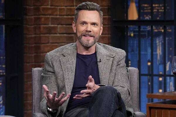 Joel McHale during an interview with Seth Meyers