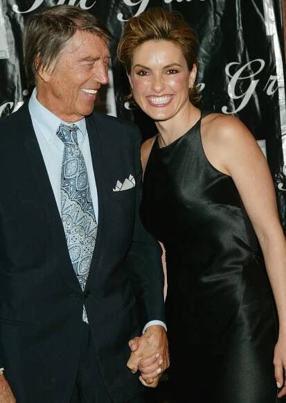 Mickey Hargitay and Mariska Hargitay smiling on a red carpet together and holding hands
