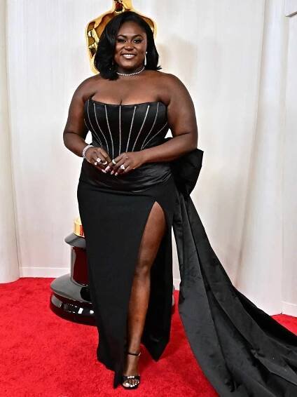 Danielle Brooks wears a black gown with sparkly detailing to the 2024 Oscars