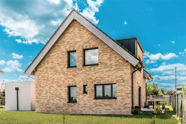 a brick house with two windows on the front