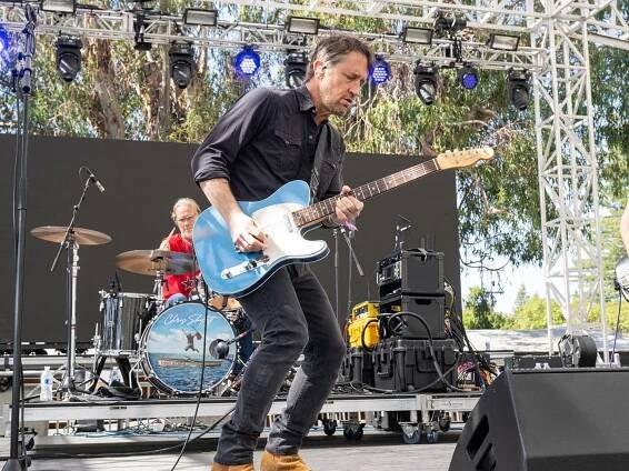 Chris Shiflett playing a blue Telecaster on stage