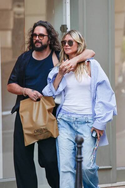 Heidi Klum and Tom Kaulitz walking arm in arm in Paris.