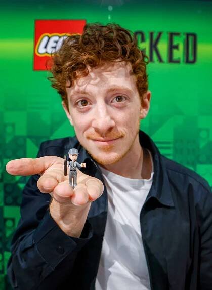 Actor Ethan Slater poses with new LEGO Wicked sets