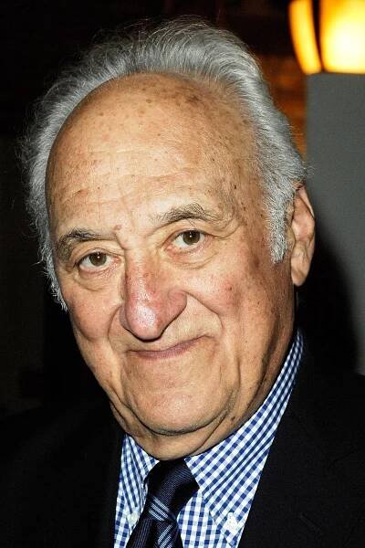 A close-up of Jerry Adler, a white-haired man wearing a dark sports coat, patterned blue shirt and blue tie.