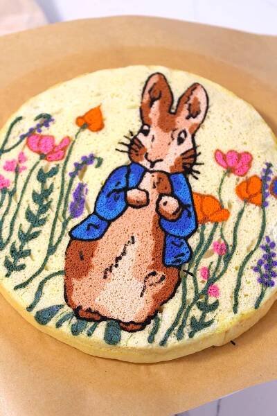 top layer of sponge cake with easter bunny design on top 