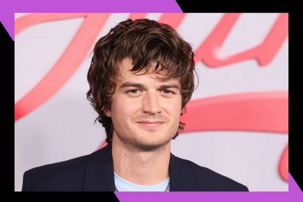 Joe Keery flashes a subtle grin on the red carpet.