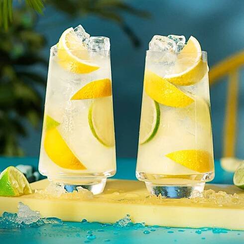 2 malibu lemonade cocktails on a yellow chopping board