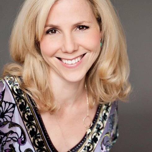 Sally Philips smiling at the camera.
