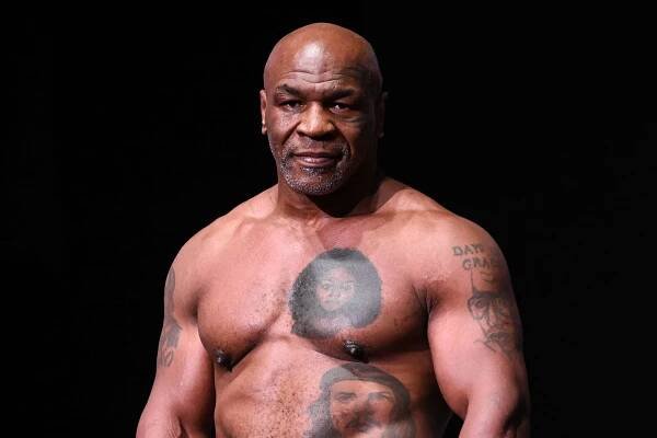 Mike Tyson gets on scale during Weigh-In at the Toyota Music Factory in Irving, Texas on November 14, 2024 ahead of his match with Jake Paul for heavyweight world titles of the Premiere Boxing Championship which will be on November 15 Friday night at AT&T Stadium in Arlington, Texas, United States