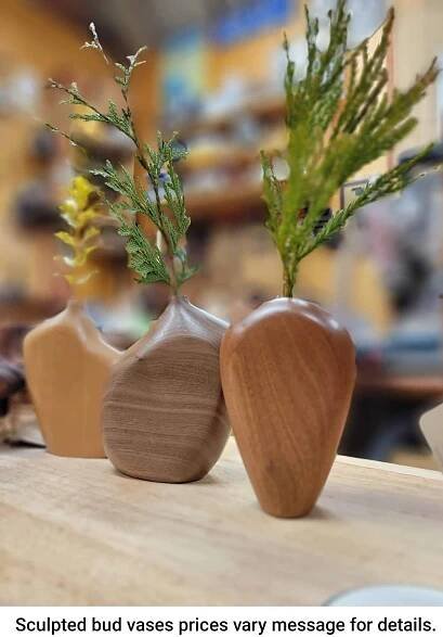 three wooden vases with plants in them on a table