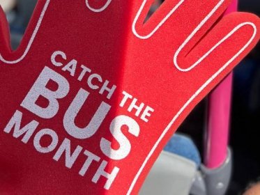 Giant red catch the bus month hand