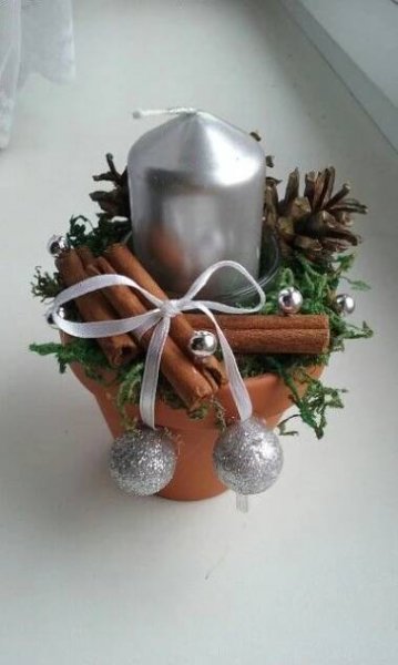 a potted plant filled with cinnamons and other christmas decorations on top of a table