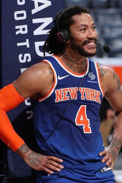 Derrick Rose #4 of the New York Knicks looks on and smiles
