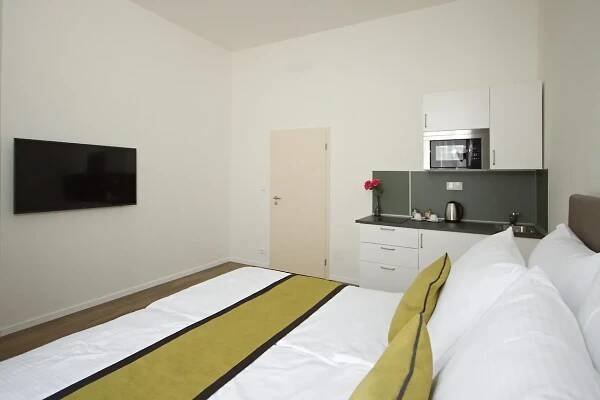 Postel nebo postele na pokoji v ubytování Elizabeth Suites