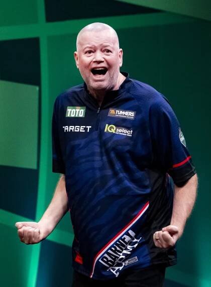 Raymond van Barneveld celebrating during a darts match.