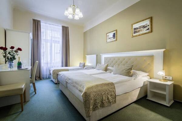 a hotel room with two beds and a desk