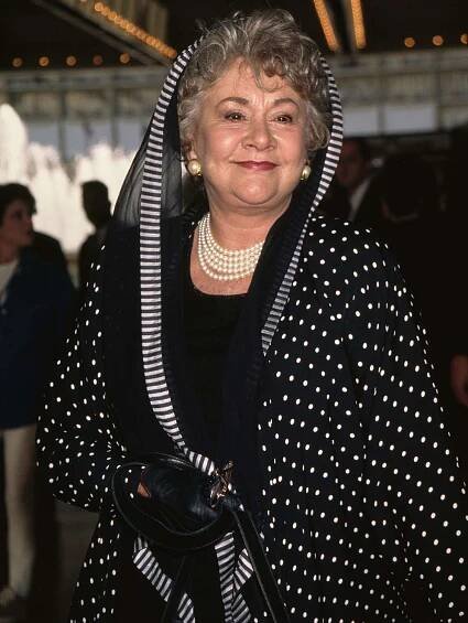 Joan Plowright, wearing a black-and-white hooded outfit, attends the opening night performance of 'Ragtime' at the Shubert Theatre in Century City, California in1997.