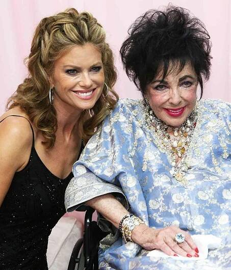 Model Kathy Ireland, Dame Elizabeth Taylor, and dancer Tony Dovolani pose backstage during the Macy's Passport gala held at Barker Hangar on September 24, 2009 in Santa Monica, California