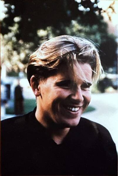 The late JD alumnus Adam Freeman Scott smiles film photograph.