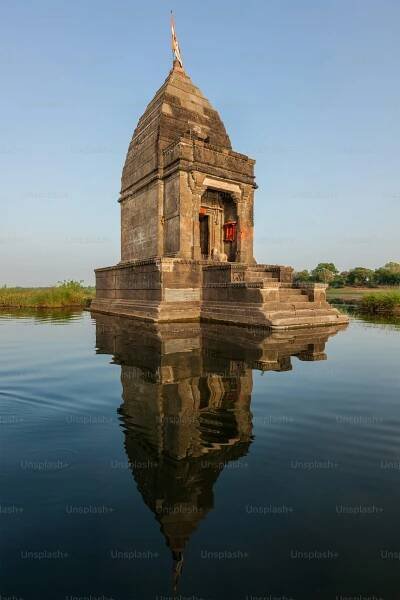 Baneswar temple (Small Hindu temple dedicated to Shiva) in the middle of the holy Narmada River, Maheshwar, Madhya Pradesh state, India