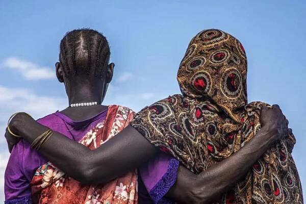Two women holding each other. 