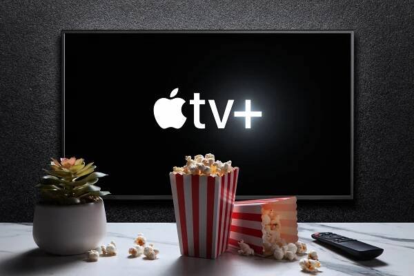 Apple TV+ logo on a TV screen, with popcorn and a remote.