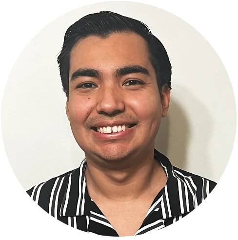 Photo of Luis Angel Martinez. Luis has dark brown medium-cropped hair, is wearing a striped dress shirt, and is smiling toward the camera.