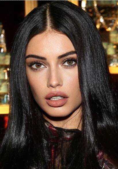 a woman with long black hair and brown eyes