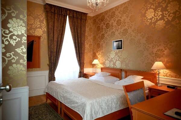 Postel nebo postele na pokoji v ubytování Zamecky Hotel Lednice