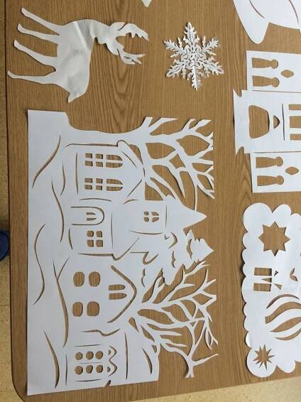cut out paper pieces sitting on top of a wooden table