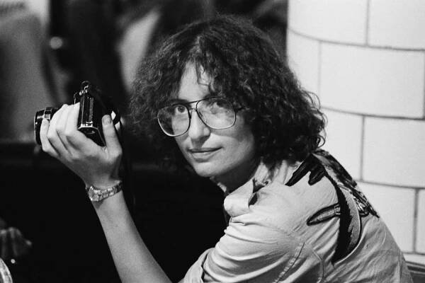 Annie Leibovitz with camera during the Rolling Stones Tour of the Americas, 1975