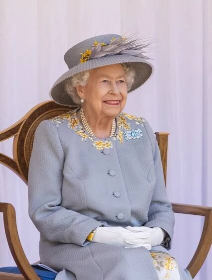 Queen Elizabeth II in a pale blue suit. 