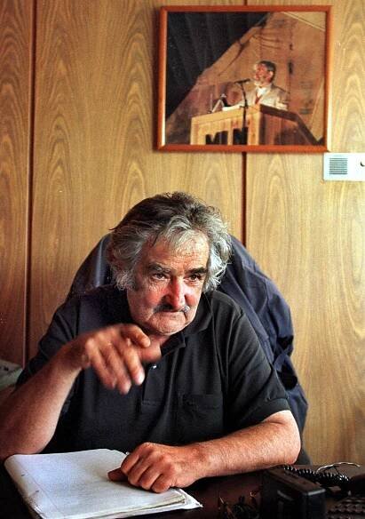 Uruguayan congressman and former leader of Tupamaro leftist guerrillas José Mujica, speaks during an interview Friday, Nov. 26, 1999 at his office in Montevideo's congress. A portrait of Raúl Sendic, late founder of the Tupamaro guerrillas movement, is seen in the background. 