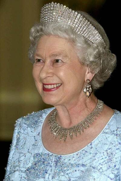 Queen Elizabeth Ll Attending A Dinner At The Governor General's Residence, Kings House, Wearing The Russian Fringe Diamond Tiara [ Originally Given To Princess Alexandra For Her Silver Wedding Anniversary In 1888 ] With A Diamond Necklace And Diamond Earrings.