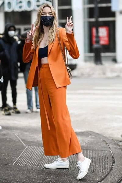 Martha Hunt is seen wearing an orange Jason Wu suit outside the Jason Wu show during New York Fashion Week F/W21 on February 14, 2021 in New York City