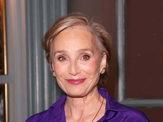 Kristin Scott Thomas looks radiant in purple wrap dress for press event