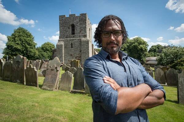 David Olusoga at St Michaels Church, Burgh-by-Sands. A Roman Fort guarded by African troops once stood on this site. 