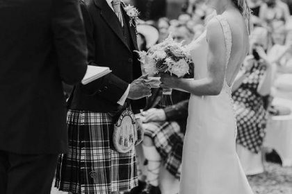 wedding couple holding hands at their melrose abbey wedding ceremony