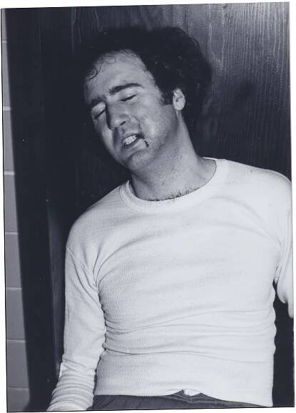 Kaufman with blood dripping from his mouth in black and white film photo