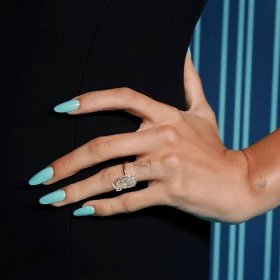 Hailey Bieber in a black dress with Tiffany blue nails.